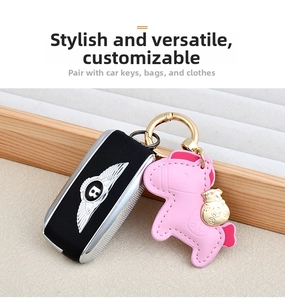 Detail of pink leather horse charm with fine stitching and golden coin bag ornament
