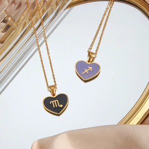 Y2K style heart necklaces with Scorpio and Sagittarius signs on a mirror