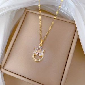 Gold titanium steel floral necklace with micro-pave cubic zirconia on beige box