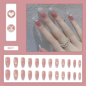 Detail of long trapezoid pink gradient press-on nails with 3D bears and pearls