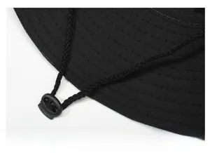 Detail of adjustable windproof drawstring with plastic toggle on black sun hat