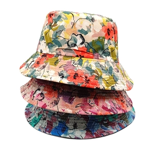 Three stacked floral sun hats in yellow, pink, and blue cotton for summer vacations