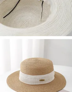 Detail of adjustable inner cord and metal logo on khaki flat top wide brim straw sun hat