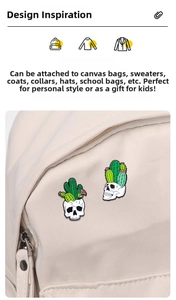 Detail of enamel cactus skull pins on a beige canvas bag showing punk style metal texture