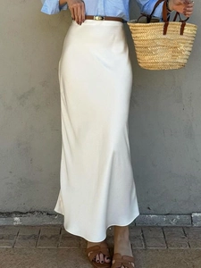 Elegant white satin maxi skirt for women paired with a blue striped shirt and brown belt