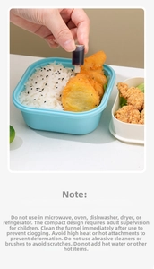 Mini plastic sauce squeeze bottle dispensing dressing into a bento box with a funnel