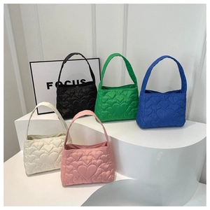 Détails de cinq sacs à main matelassés en cœur en noir, vert, bleu, blanc et rose