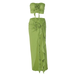 Detail view of grass green strapless top with 3D rose and ruffled split maxi skirt