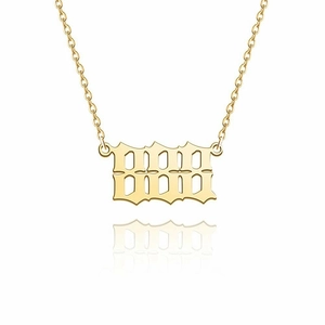 Detail view of 14K gold stainless steel 1996 gothic number necklace on white backdrop