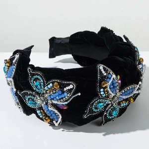 Detail of luxury black velvet headband with beaded blue butterflies and faux pearls