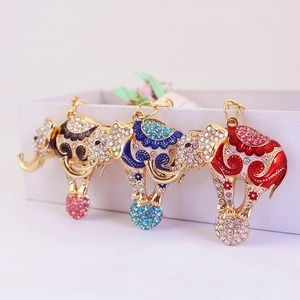 Three creative flying elephant keychains with rhinestones and enamel in black blue and red