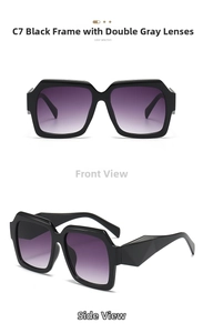 Detail view of large square sunglasses with thick black frames and gradient lenses
