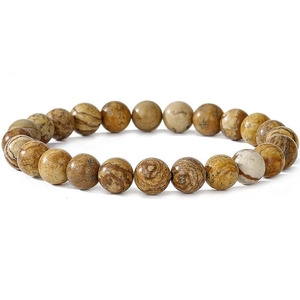 Macro shot of natural agate stone beads with wood grain patterns on a white background