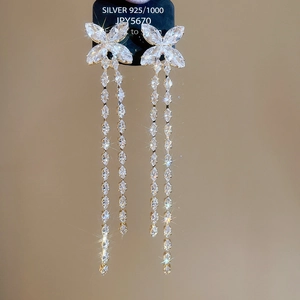 Detail of silver S925 butterfly tassel earrings with sparkling zircon crystals