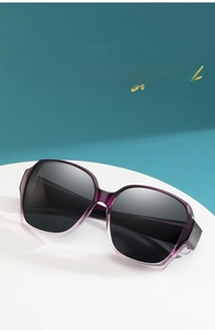 Detail of oversized geometric polarized sunglasses with purple gradient frame for women