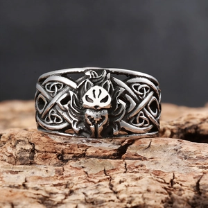 Punk style Viking wolf head ring in vintage silver stainless steel on wooden surface