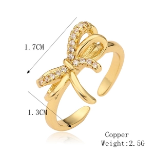 Macro detail of copper bowknot ring with cubic zirconia and dimension labels
