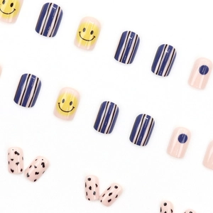 Short square press-on nails set with mixed patterns of blue stripes and yellow smileys