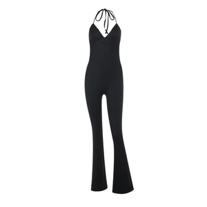 Front view of black halter neck backless catsuit with flared legs on white background