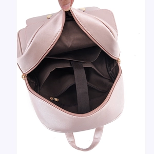 Pink faux leather backpack showing internal compartments and laptop sleeve