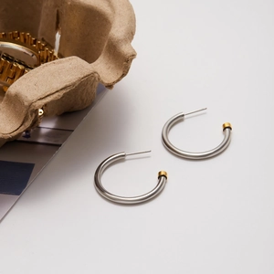 Minimalist stainless steel C-shape earrings with silver finish and gold-tone end accents