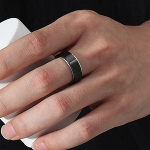 Minimalist black stainless steel rotating ring for men shown worn on a model's finger
