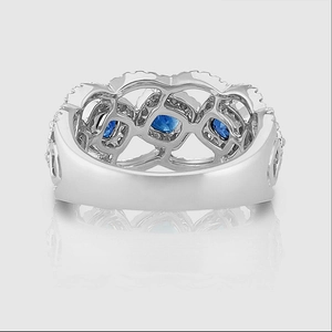 Close-up of vintage hollow silver ring with sapphire blue stones and pavé diamonds