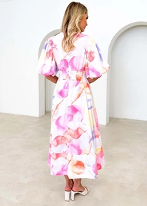Back view of a long floral A-line dress with puff sleeves and watercolor print details