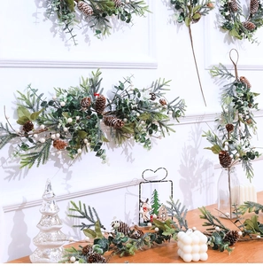 Detail of Christmas garland with pine cones and white berries for wall and table decor