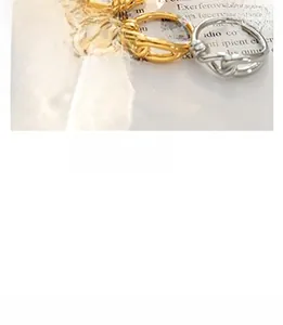 Detailed view of three minimalist interlocking gold and silver chain rings for layering