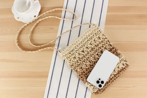 Close-up of handmade gradient woven bag showing interior capacity with a phone inside