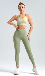 Detail of high waist yoga leggings with functional side pockets and elastic matte fabric
