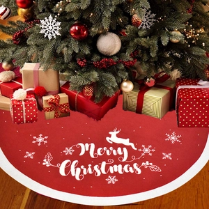 Red knit Christmas tree skirt with reindeer snowflake patterns and white fur trim edge
