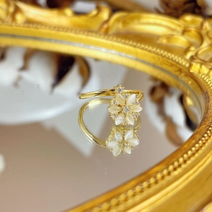 Elegant rotating cat-eye flower ring in gold finish with adjustable open band for women