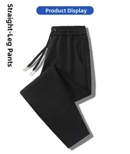 Detail of straight leg sports pants featuring elastic drawstring waist and zip pockets