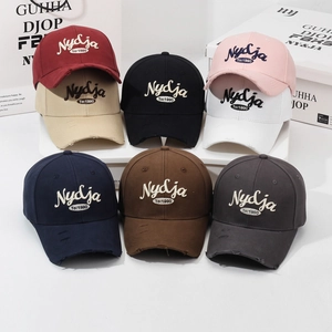Vintage cotton baseball caps with Nydja embroidery and distressed brim in eight colors