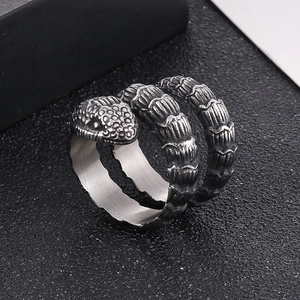 Macro shot of silver snake ring featuring detailed scales and vintage punk style wrap design