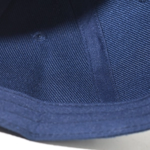 Detailed macro view showing interior stitching and twill fabric texture of the baseball cap