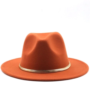 Detailed close-up of orange wool fedora hat featuring an elegant gold chain embellishment