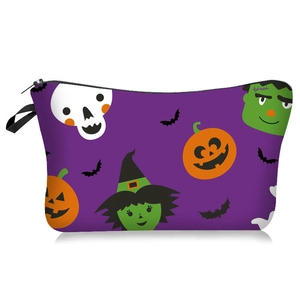 Macro detail of Halloween makeup bag with skull and pumpkin patterns and black handle
