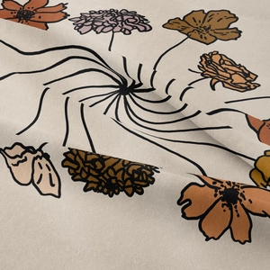 Detail of bohemian wall tapestry with retro floral patterns on cream fabric texture
