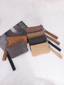 Set of six colorful washed canvas coin purses with wrist straps and zippers on fabric