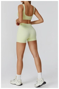 Rear view of high waist yoga shorts and sports bra set with white contrast piping details