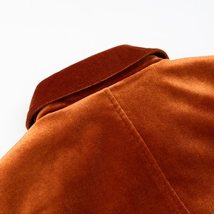 Detail of caramel velvet jacket showing back collar structure and premium fabric texture