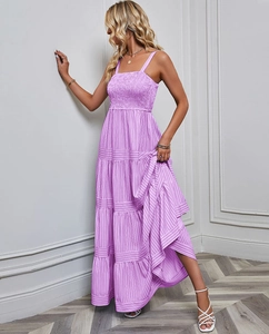 Detail view of purple striped maxi dress with tiered skirt and smocked bodice texture
