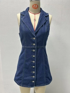 Detail view of V-neck denim dress showing metal buttons and premium stitching