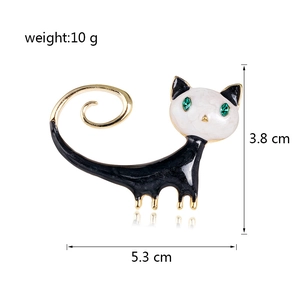Cute black and white enamel cat brooch with green gem eyes and gold plated tail detail