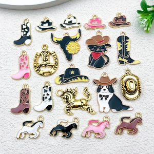 Flat lay of colorful enamel cowboy hat and boot charms for DIY jewelry making