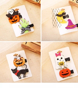 Close-up of Halloween hair clips featuring felt pumpkin, ghost, and witch hat designs