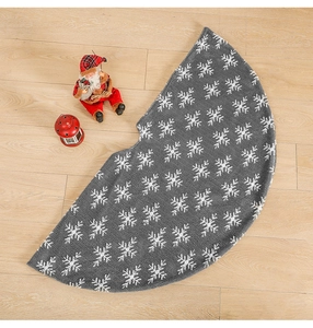 Detailed texture of grey plush Christmas tree skirt with white snowflake patterns